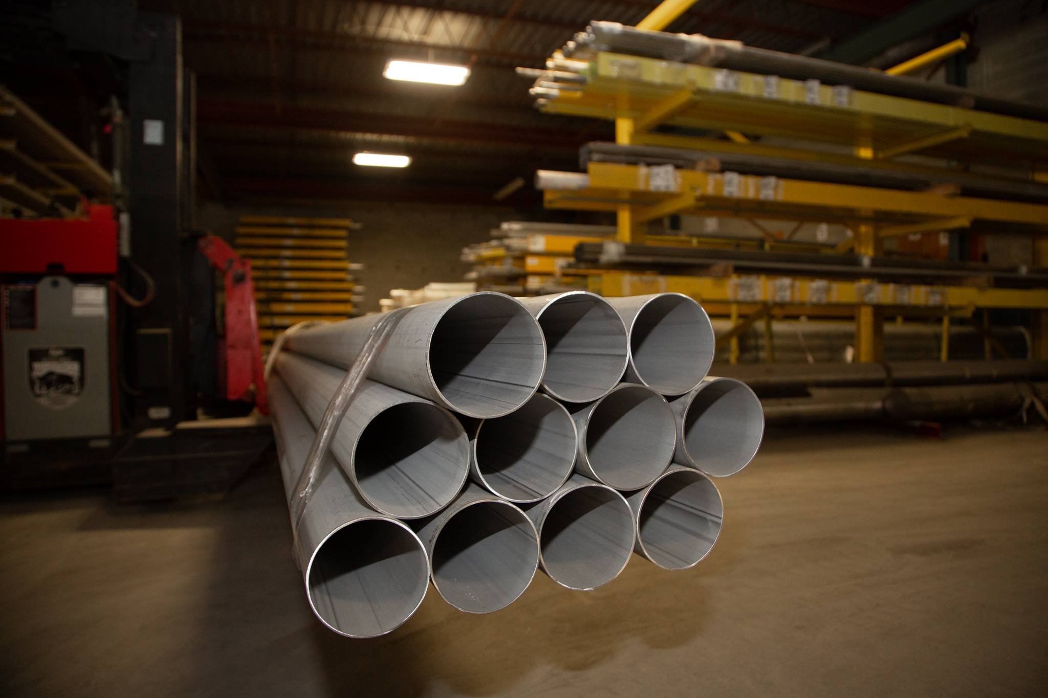 stainless steel pipes stacked together in forklift